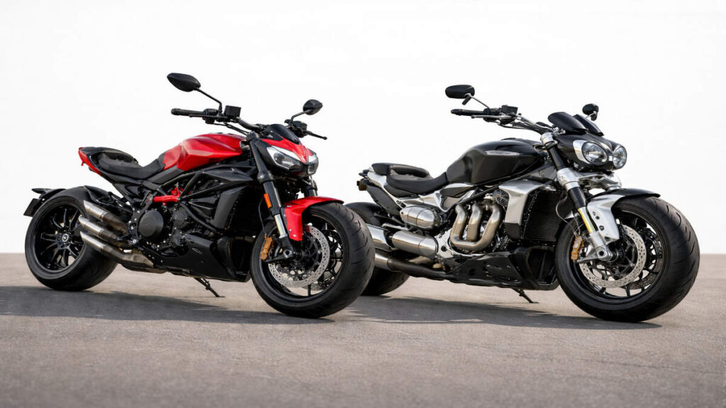 Ducati XDiavel V4 and Triumph Rocket 3 motorcycles on a plain background in natural daylight